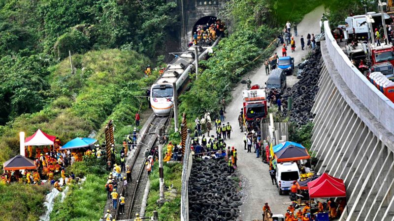 This photo shows rescue workers at the site where a train derailed inside a tunnel in the mountains of Hualien, eastern Taiwan on April 2, 2021. (Photo by Sam Yeh / AFP)