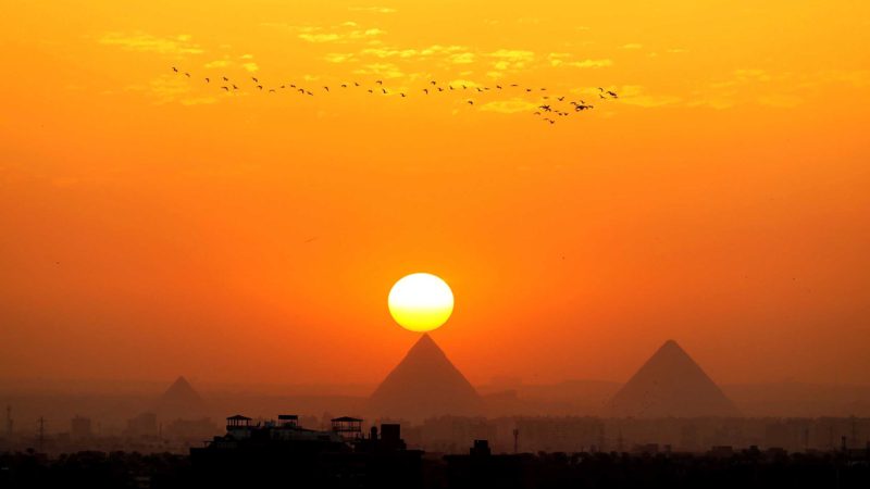 (210414) -- CAIRO, April 14, 2021 (Xinhua) -- Photo taken on April 14, 2021 shows the Giza Pyramids at sunset seen from Cairo, Egypt. (Xinhua/Sui Xiankai)