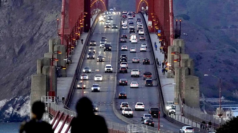 FILE - In this Nov. 12, 2020, file photo, traffic moves on the Golden Gate Bridge in San Francisco.  The San Francisco Chronicle reported Saturday, May 15, 2021, that the iconic span started emanating a loud hum following a retrofit last year of the sidewalk safety railing on its western side. Crews replaced some 12,000 wide slats with narrower ones, to give the bridge a slimmer profile and make it safer in high winds. (AP Photo/Jeff Chiu, File)