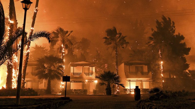 Fire burns among houses during a wildfire in the village of Schinos, near Corinth, Greece, late Wednesday, May 19, 2021. A large wildfire west of Athens damaged homes and prompted evacuations as it tore through rugged forest terrain. Fire Service officials said eight water-dropping planes and three helicopters were involved to try and contain the blaze some 70 kilometers (45 miles) west of Athens, outside the resort town of Loutraki. (AP Photo/Valerie Gache)