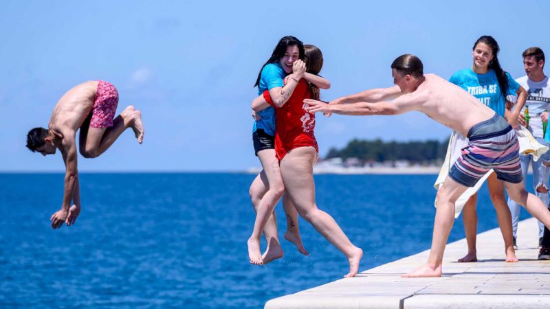 (210525) -- ZADAR (CROATIA), May 25, 2021 (Xinhua) -- Secondary school students jump into the sea to celebrate the end of a school year in Zadar, Croatia, on May 25, 2021. The celebration of "Norijada" (Crazy Day) is held annually nationwide in Croatia to mark the end of a school year. (Dino Stanin/Pixsell via Xinhua)