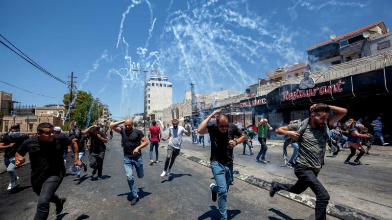 (210518) -- BETHLEHEM, May 18, 2021 (Xinhua) -- Protesters run to evade tear gas canisters fired by Israeli soldiers during a protest against the continued Israeli airstrikes on the Gaza Strip, in the West Bank city of Bethlehem, on May 18, 2021. (Photo by Luay Sababa/Xinhua)