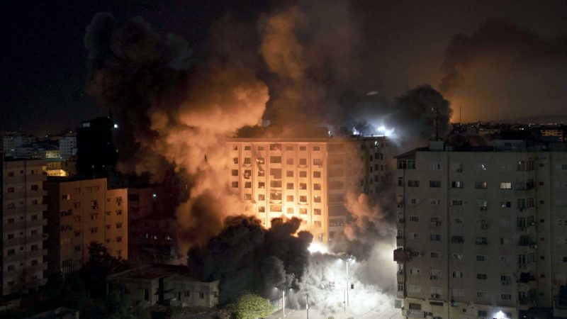 Smoke caused by Israeli airstrikes are seen at a residential building in Gaza City, early Wednesday, May 12, 2021. (AP Photo/Khalil Hamra)