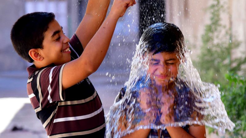 (210629) -- DAMASCUS, June 29, 2021 (Xinhua) -- Syrian children cool off with water during hot weather in Damascus, Syria, on June 29, 2021. (Photo by Ammar Safarjalani/Xinhua)