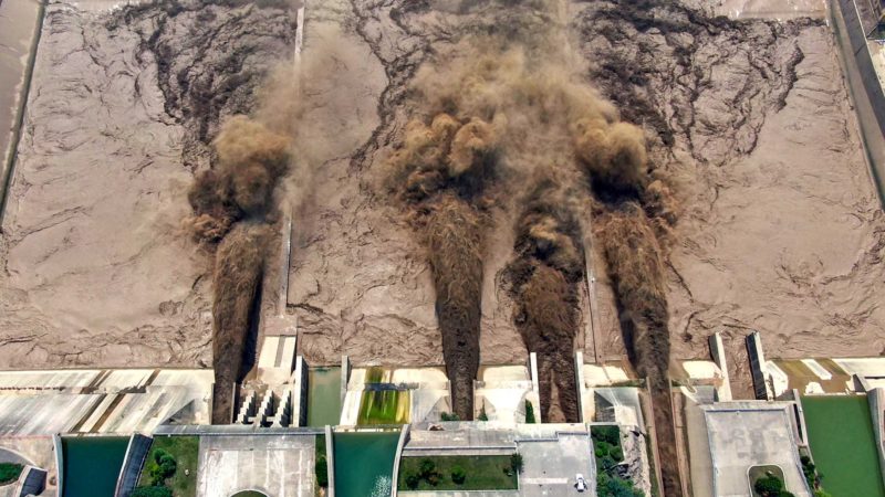 This photo taken on July 5, 2021 shows water being released from the Xiaolangdi Reservoir Dam in Luoyang in China's central Henan province. (Photo by STR / AFP) / China OUT