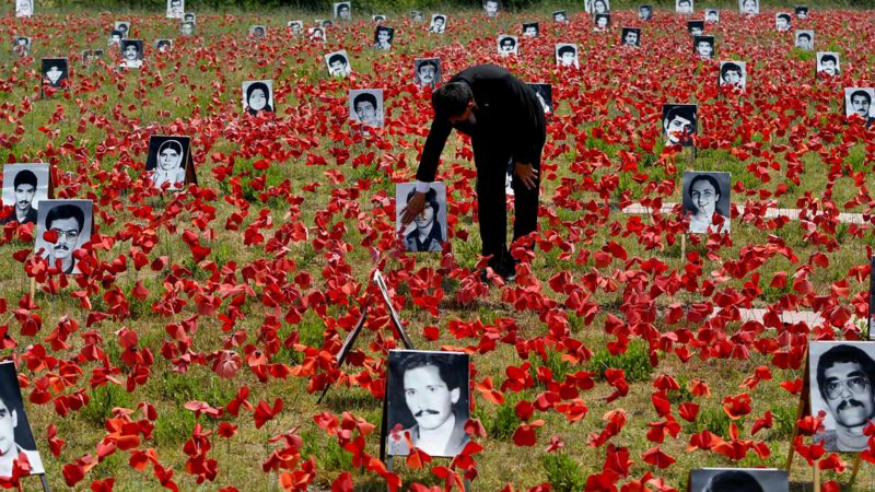 TOPSHOT - A Mujahedin-e Khalq member visits a memorial created in honor of the execution of 30,000 political prisoners by the Iranian regime, which took place in the summer of 1988, inside of Ashraf-3 camp, in the Albanian town of Manza, on July 10, 2021. (Photo by Gent SHKULLAKU / AFP)