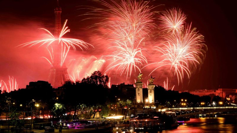 TOPSHOT - Fireworks explode above the Eiffel Tower and the Seine river as part if the annual Bastille Day celebrations in Paris, on July 14 2021. (Photo by Bertrand GUAY / AFP)