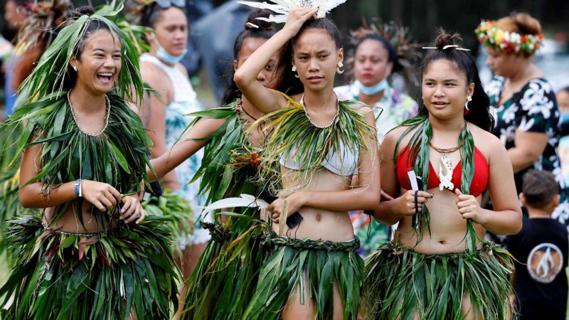 Marquesan islanders gather ahead of the arrival of France's President Emmanuel Macron at the Hiva Oa stadium in the Marquesas Islands, French Polynesia on July 25, 2021. (Photo by Ludovic MARIN / AFP)