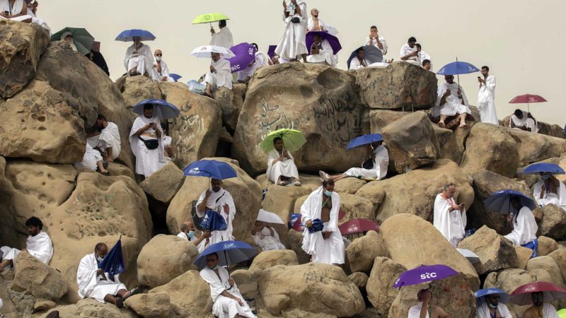 Muslim pilgrims pray on top of the rocky hill known as the Mountain of Mercy, on the Plain of Arafat, beside inscriptions which were left by pilgrims from previous years, during the annual hajj pilgrimage, near the holy city of Mecca, Saudi Arabia, Monday, July 19, 2021. The coronavirus has taken its toll on the hajj for a second year running. What once drew some 2.5 million Muslims from all walks of life from across the globe, the hajj pilgrimage is now almost unrecognizable in scale. (AP Photo/Amr Nabil)