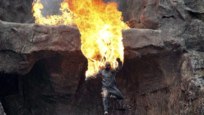 A burning stuntman jumps into the deep during an explosion as part of a performance of the Karl May play 'Der Oelprinz – Schwarzes Gold am Gloomy Water' (The Oil Prince - Black Gold at Gloomy Water) in Elspe, Germany, Thursday, July 29, 2021. The stuntman plays the dangerous parts of the play for the German actor Sebastian Kolb in his role of bad guy 'Grinley'. This year's Karl May Festival in Elspe takes place until Sept. 9, 2021. (AP Photo/Michael Sohn)