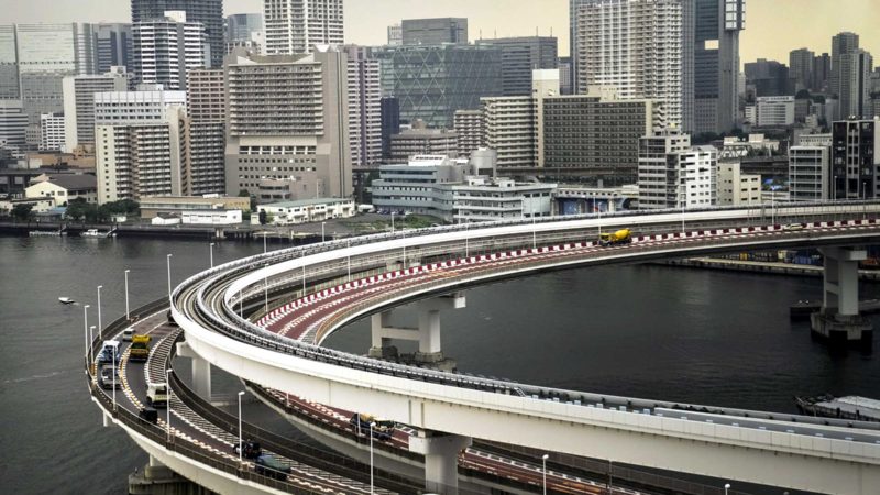 Motorists drive along a spiral ramp onto the Rainbow Bridge, Tuesday, July 13, 2021, in Tokyo. The pandemic-delayed 2020 Summer Olympics are schedule to open on July 23 with spectators banned from most Olympic events due to COVID-19 surge. (AP Photo/Jae C. Hong)