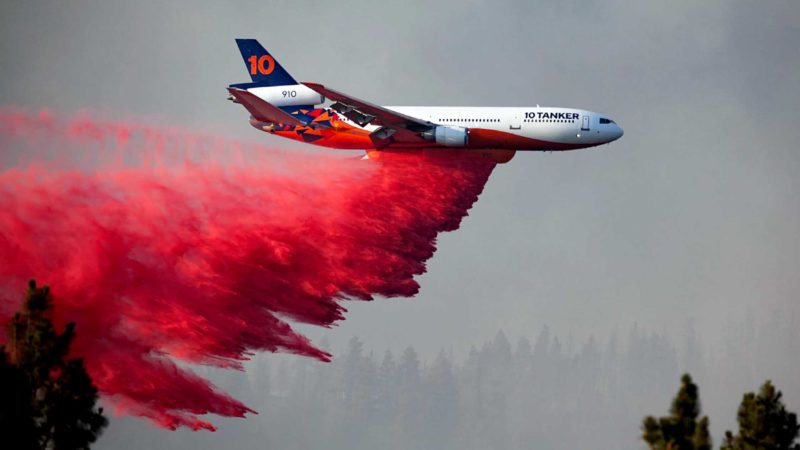 In this photo provided by the Bootleg Fire Incident Command, a DC-10 tanker drops retardant over the Bootleg Fire in southern Oregon, Thursday, July 15, 2021. Meteorologists predicted critically dangerous fire weather through at least Monday with lightning possible in both California and southern Oregon. (Bootleg Fire Incident Command via AP)