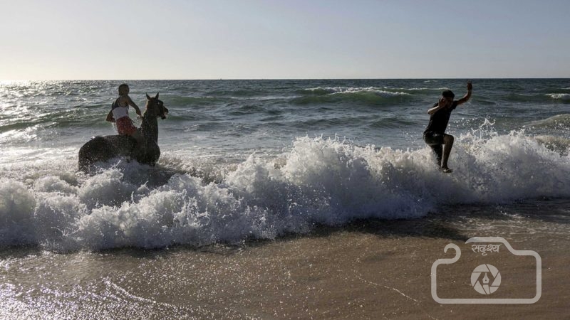 A Bedouin man rides his horse in the Mediterranean Sea during the Muslim Eid al-Adha holiday at Zikim beach, on the Israeli-Gaza border, Wednesday, July 21, 2021. (AP Photo/Tsafrir Abayov)