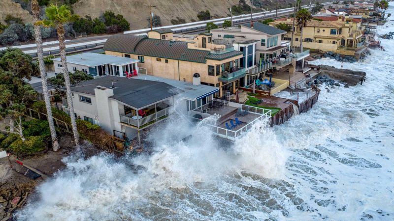 Homes along Capistrano Beach get pelted with waves during high tide in Dana Point, Calif. on Thursday, Aug. 19, 2021. (Jeff Gritchen/The Orange County Register via AP)