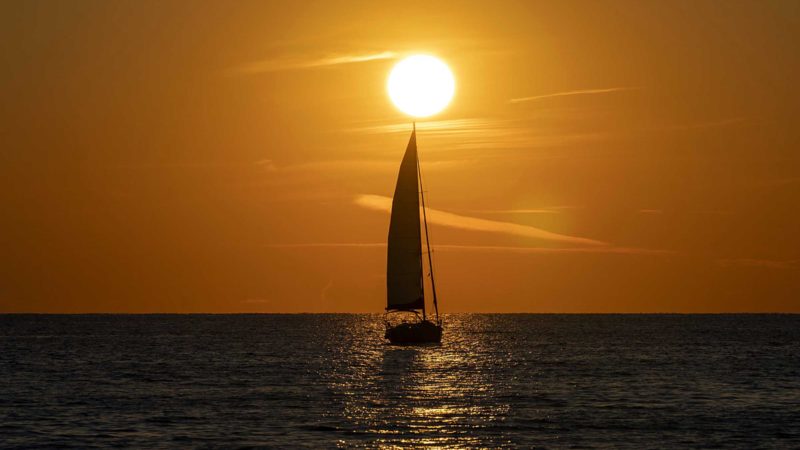 A sailing boat sails during sunset, in the Adriatic town of Rovinj, Croatia, Friday, Aug. 27, 2021. Summer tourism has exceeded even the most optimistic expectations in Croatia this year. Beaches along the country's Adriatic Sea coastline are swarming with people. Guided tours are fully booked, restaurants are packed and sailboats were chartered well in advance.  (AP Photo/Darko Bandic)