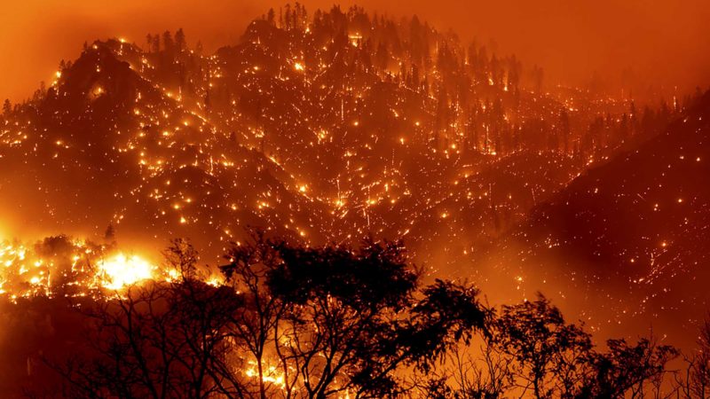 In this long exposure photo embers light up hillsides as the Dixie Fire burns near Milford in Lassen County, Calif., on Tuesday, Aug. 17, 2021. (AP Photo/Noah Berger)