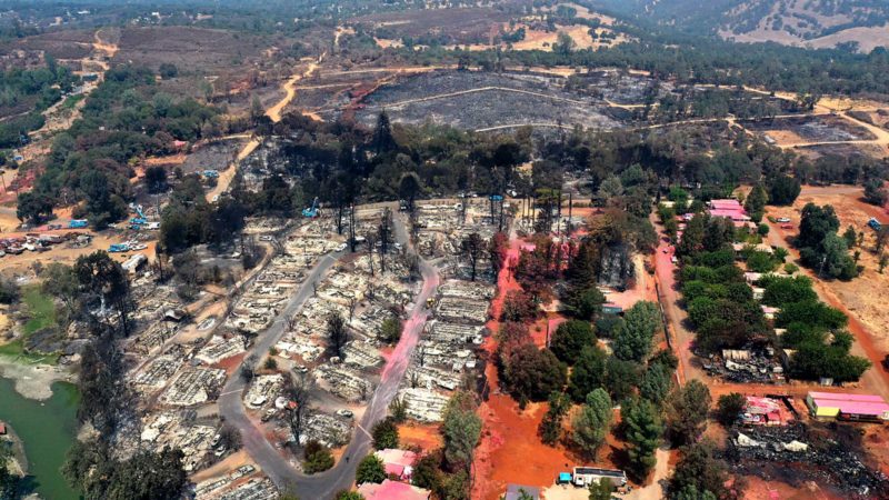 CLEARLAKE, CALIFORNIA - AUGUST 19: In an aerial view, burned mobile home are visible at the Creekside Mobile Home Park a day after being destroyed by the Cache Fire on August 19, 2021 in Clearlake, California. The fast moving Cache Fire destroyed dozens on homes on Wednesday afternoon an charred over 80 acres. The fire is 30 percent contained.   Justin Sullivan/Getty Images/AFP  == FOR NEWSPAPERS, INTERNET, TELCOS & TELEVISION USE ONLY ==