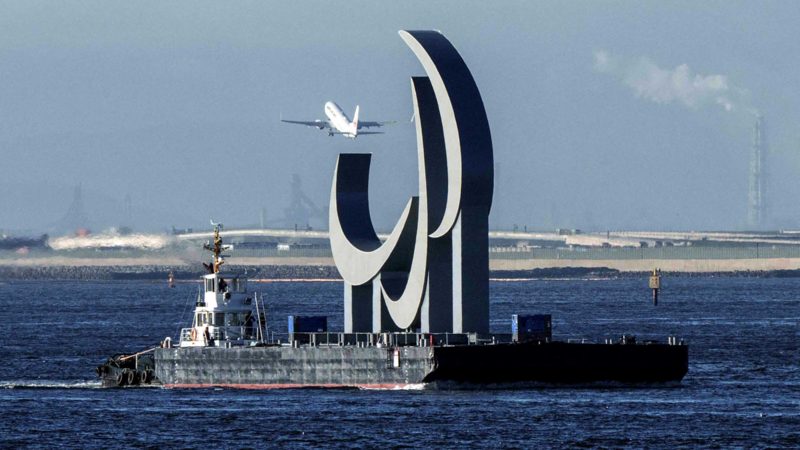 The Paralympic Symbol "the three agitos", 23.4m wide and 17.5m high, is brought by a salvage barge to install at Tokyo Waterfront on August 20, 2021, four days before the opening of the Tokyo 2020 Paralympic Games. (Photo by Yasuyoshi CHIBA / AFP)