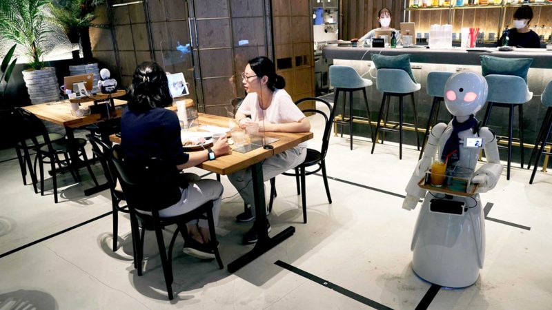 In this picture taken on August 17, 2021, a humanoid robot delivers drinks to customers at the Dawn Cafe in Tokyo. - The cafe's launch comes with the Paralympics due to open on August 24 and disability advocates debating Japan's progress on inclusion and accessibility. (Photo by Behrouz MEHRI / AFP) / TO GO WITH Paralympics-2020-2021-Japan-Disabled-Rights-Employment-Robot by Shingo ITO