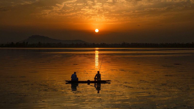 (210828) -- SRINAGAR, Aug. 28, 2021 (Xinhua) -- Fishermen catch fish in Dal Lake at sunset in Srinagar, the summer capital of Indian-controlled Kashmir, on Aug. 28, 2021. (Xinhua/Javed Dar)