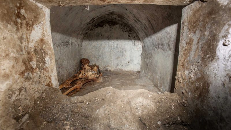 In this undated photo released by the Pompeii archeological park, a view of the tomb located in the necropolis of Porta Sarno, in an area not yet open to the public in the east of Pompeii’s urban center. Archaeologists in the ancient city of Pompeii have discovered a remarkably well-preserved skeleton during excavations that also shed light on the cultural life of the city before it was destroyed by a volcanic eruption in AD 79. The discovery is unusual since most adults were cremated at the time. (Alfio Giannotti/Pompeii Archeological Park via AP)