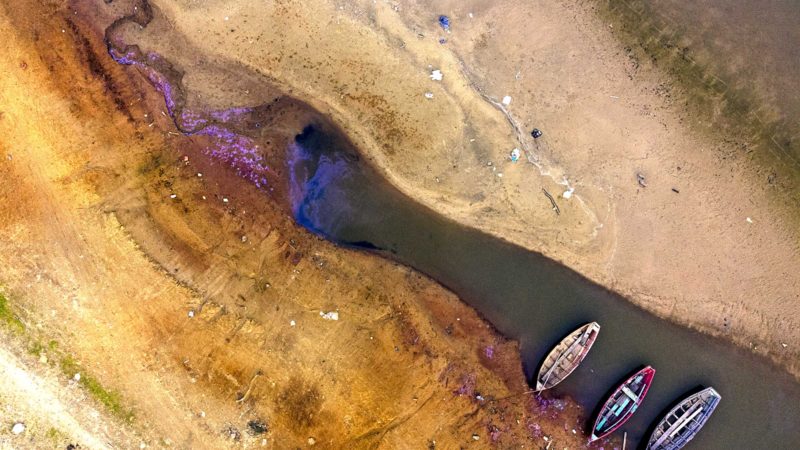 Boats languish over the last pools of water available on the Payagua stream that reaches the Paraguay river amid a historic drought that is affecting its levels, in Mariano Roque Alonso, Paraguay, Monday, Sept. 20, 2021. (AP Photo/Jorge Saenz)