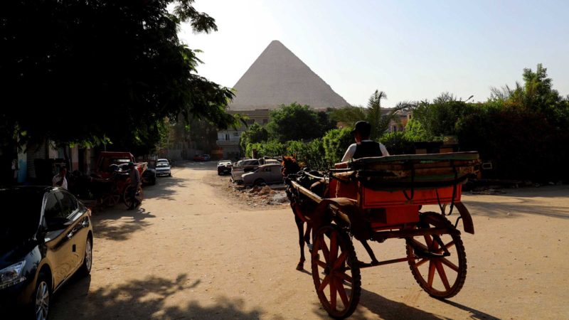 (210920) -- CAIRO, Sept. 20, 2021 (Xinhua) -- A carriage runs on a road in a residential area outside of the Great Pyramid of Giza, Egypt, on Sept. 19, 2021. (Xinhua/Sui Xiankai)