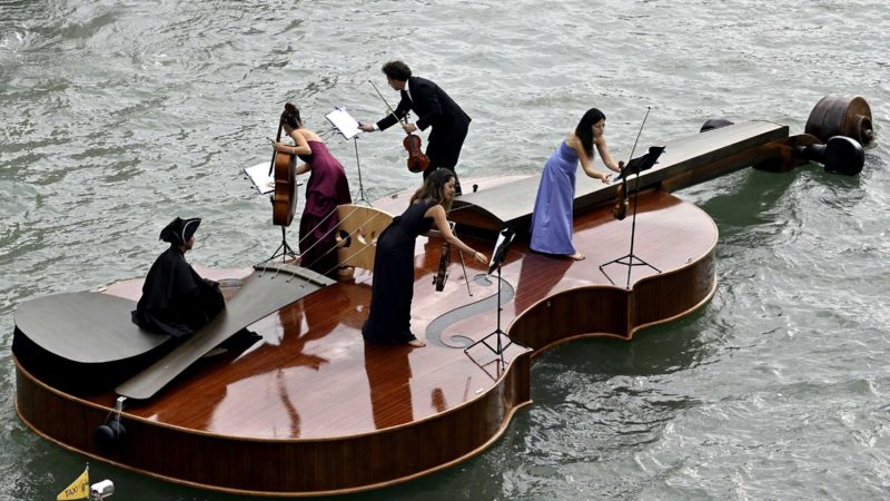 Musicians prepare to play on a boat shaped like a violin, during a parade along the Grand Canal in Venice, Italy, Saturday, Sept. 18, 2021. (Alessandro Masini/LaPresse via AP)