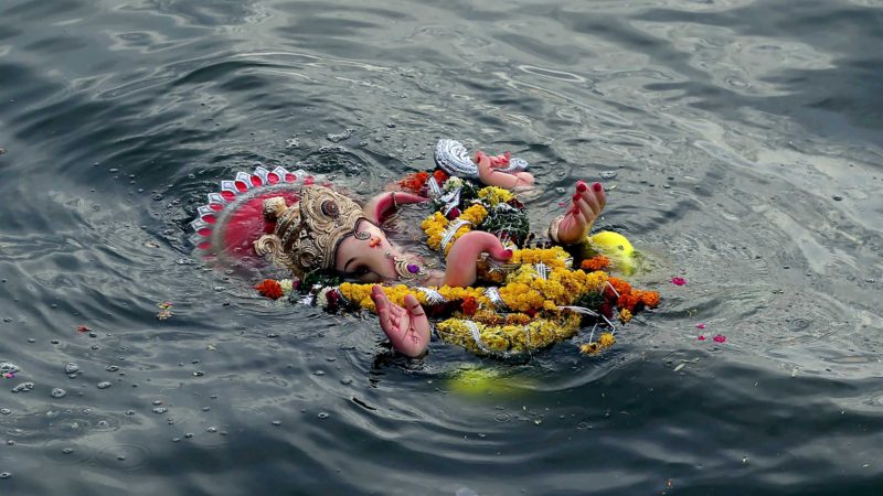 An idol of elephant-headed Hindu god Ganesha floats in Hussain Sagar Lake after it was immersed by devotees on the ninth day of the ten-day long Ganesh Chaturthi festival in Hyderabad, India, Saturday, Sept. 18, 2021. The festival is a celebration of the birth of Ganesha, the Hindu god of wisdom, prosperity and good fortune. (AP Photo/Mahesh Kumar A.)