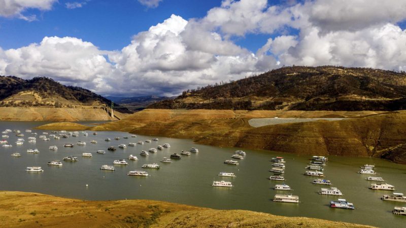 Houseboats float on Lake Oroville, Monday, Oct. 25, 2021, in Oroville, Calif. Recent storms raised the reservoir more than 16 feet, according to the California Department of Water Resources. (AP Photo/Noah Berger)