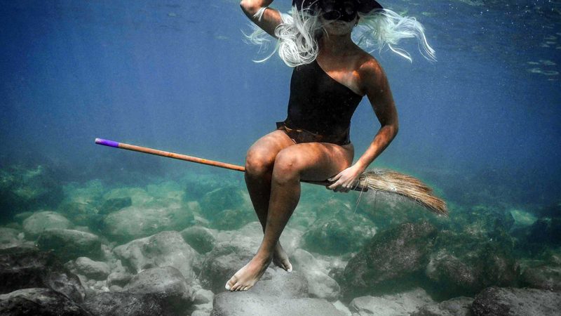 A woman dressed in a Halloween costume swims along the coast of the northern Lebanese city of Batroun, on October 28, 2021. (Photo by Ibrahim CHALHOUB / AFP)