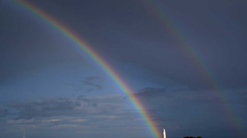 A double rainbow is seen over St Mary's Lighthouse in Whitley Bay, England, Monday, Oct. 4, 2021. (Owen Humphreys/PA via AP)